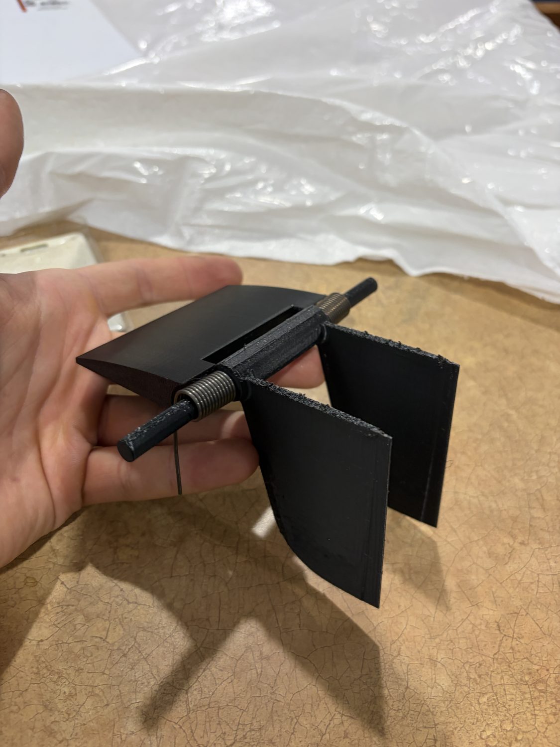 The final twin-fin keel unit held in hand, blades on a single spring-loaded shaft