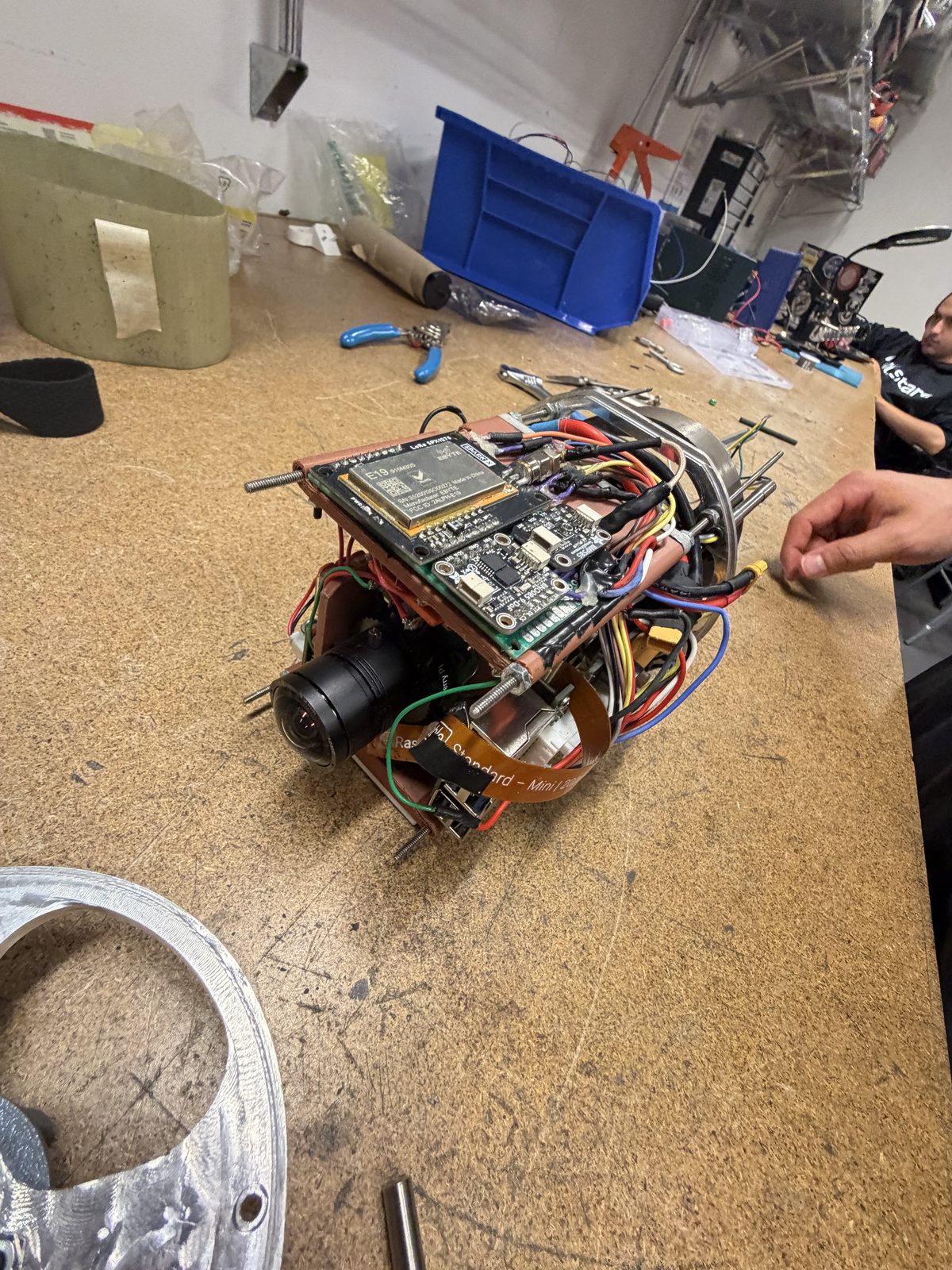 The payload during assembly on the NUSTARS workbench with tools and hardware around it