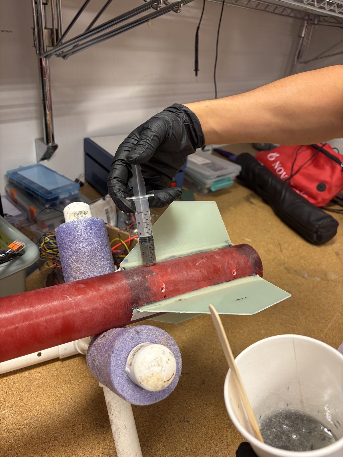 Injecting carbon-fiber-filled epoxy at the fin root with a syringe