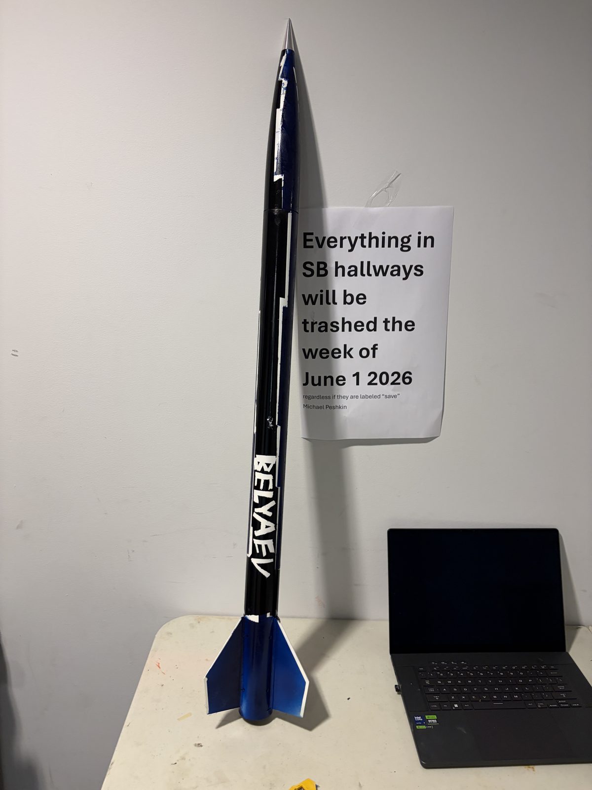 Finished L1 certification rocket, painted navy with BELYAEV on the airframe