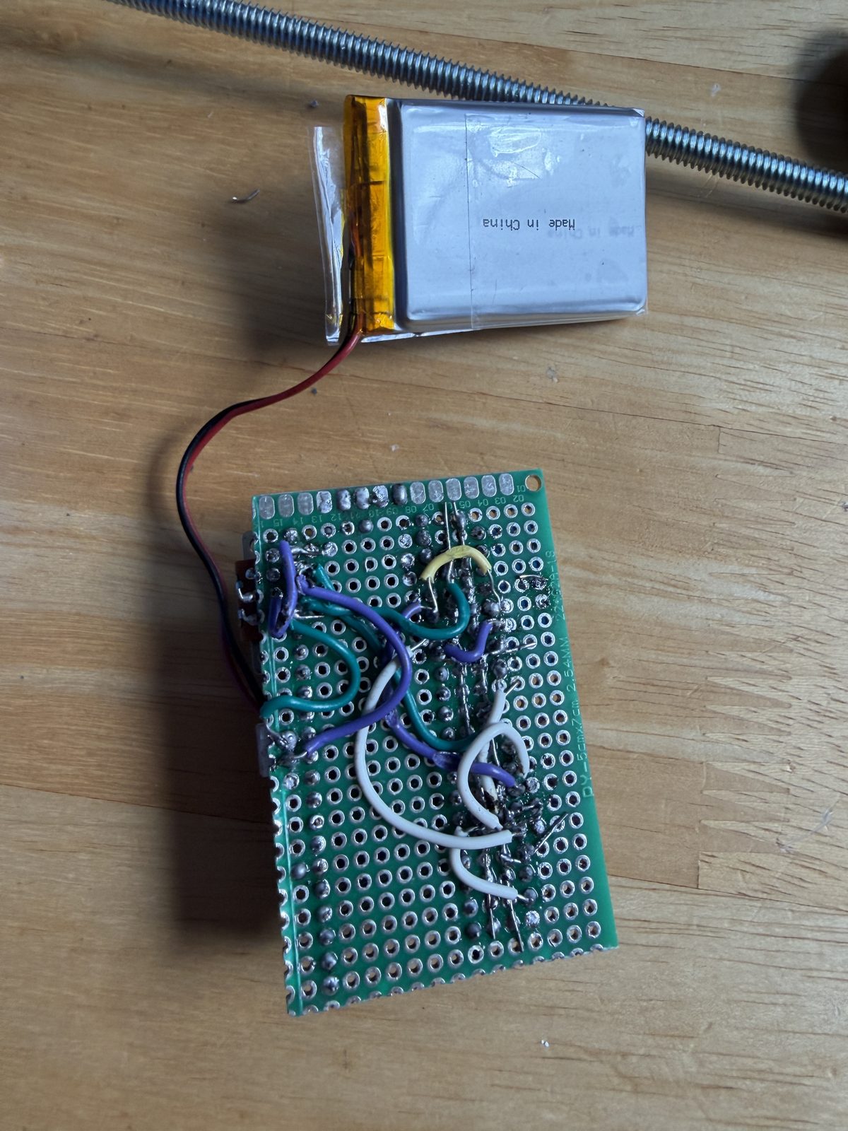 Solder side of the perfboard showing the hand-soldered wiring