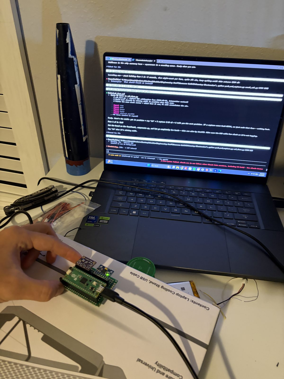 Flight board connected to a laptop running the firmware validation session